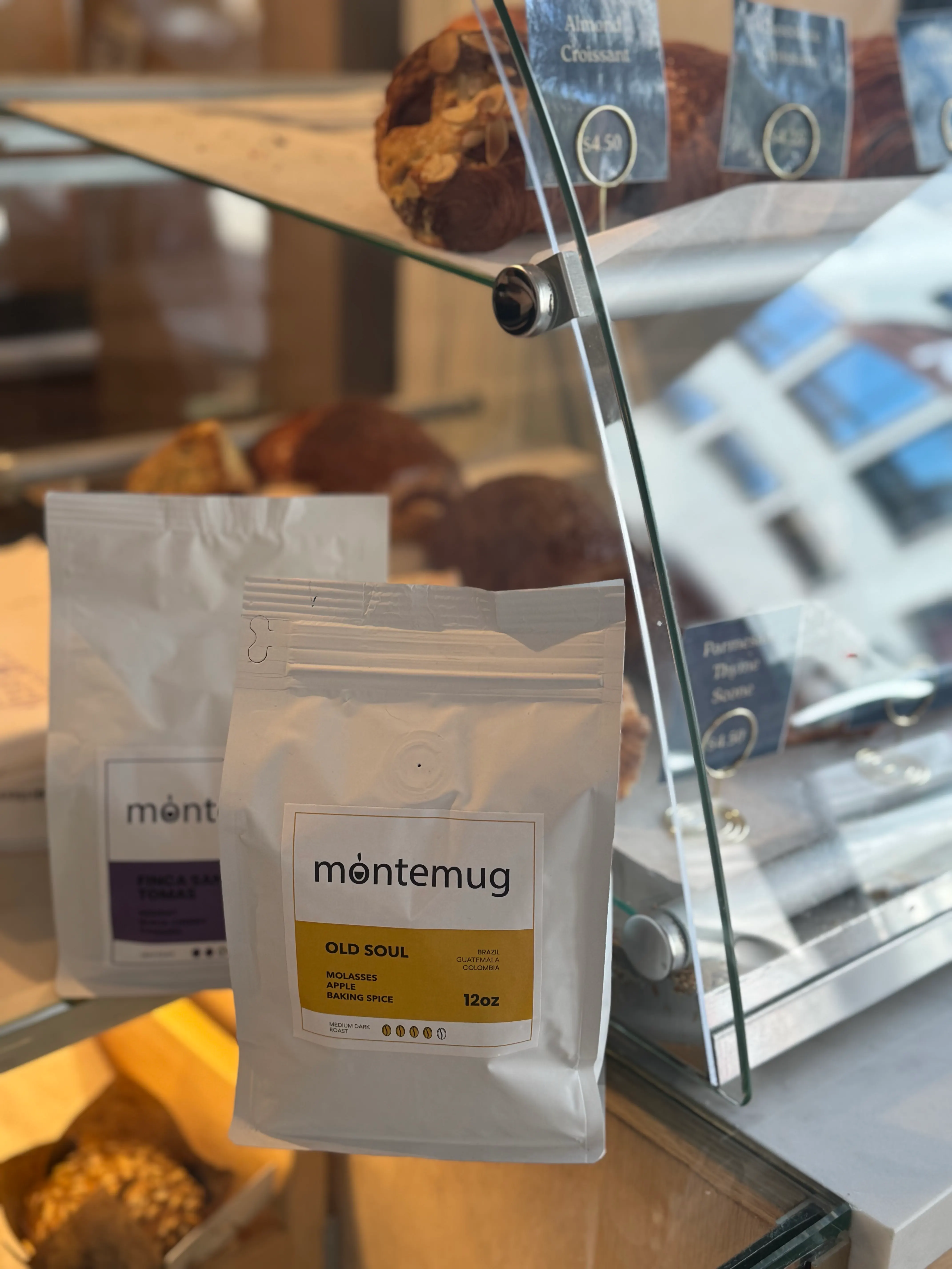 Montemug coffee bean bags displayed by the pastry case