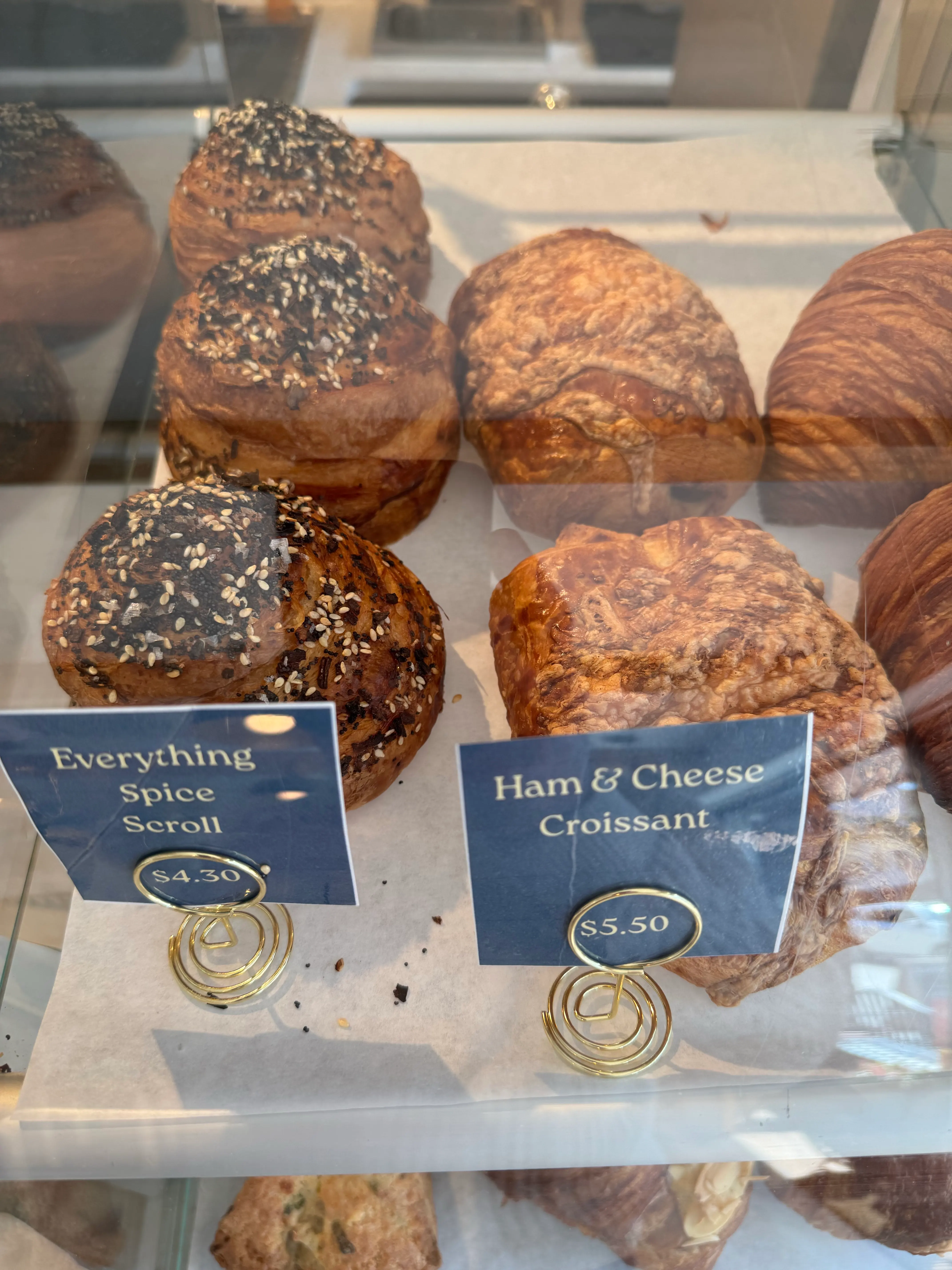 Everything spice and ham and cheese croissants in the case