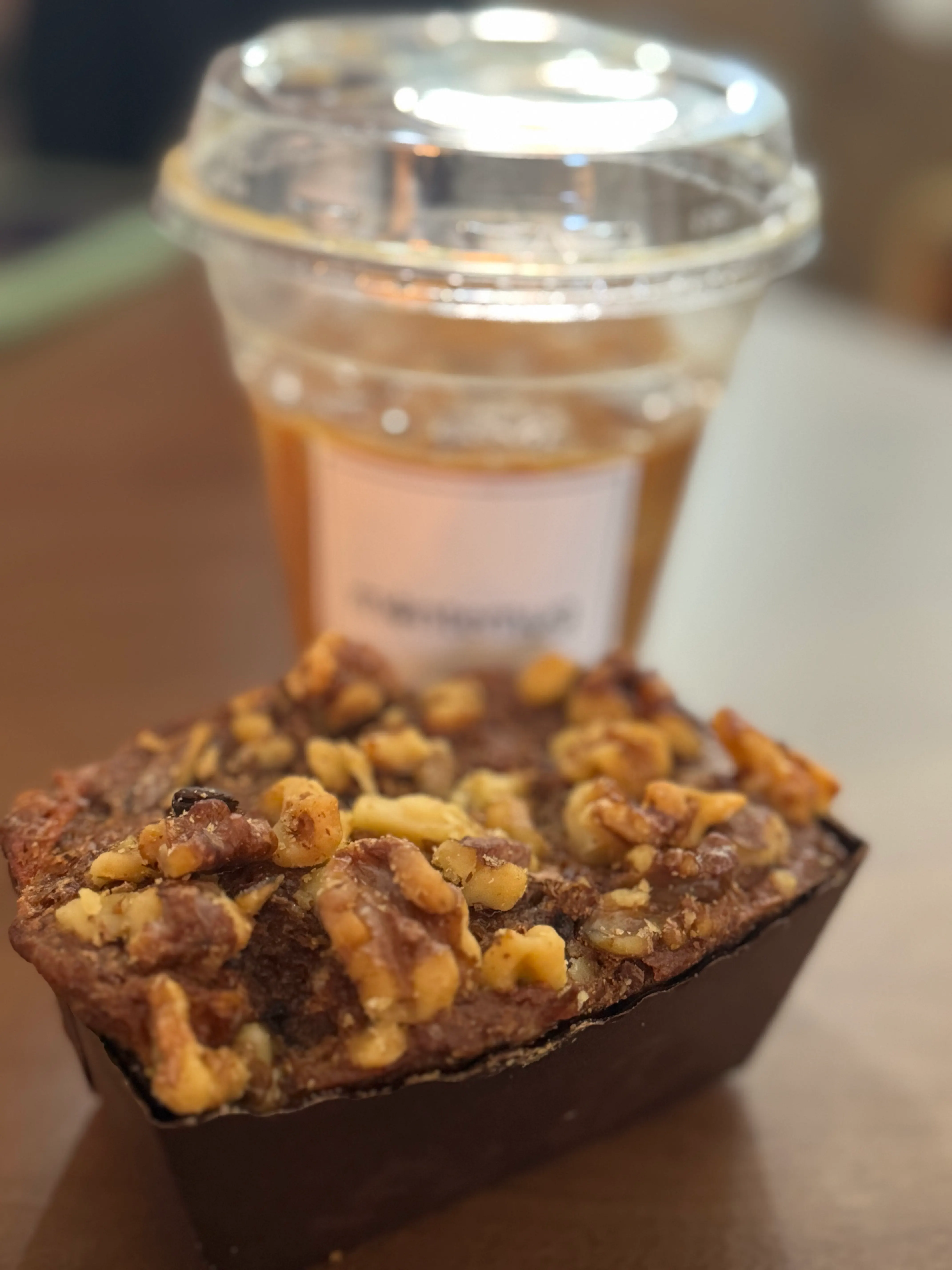 Walnut loaf in front of an iced coffee